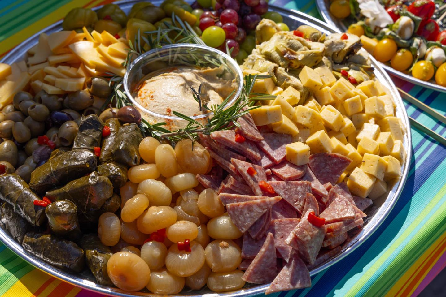 Charcuterie platter with cheeses, meats, and olives.